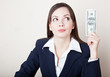 Woman is looking at 100 dollars banknote Woman is looking at 100 dollars banknote