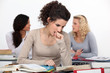 A young university student reviewing her textbooks before class