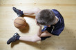 Kid with basketball on floor
