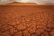 Photo: Cracked pattern of dry lake bed and sand dunes in Sahara Desert Cracked pattern of dry lake bed and sand dunes in Sahara Desert