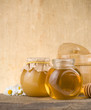 glass jar full of honey and stick glass jar full of honey and stick