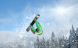 Snowboarder at jump inhigh mountains at sunny day