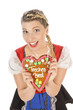 Blonde junge Frau im Dirndl mit Lebkuchenherz