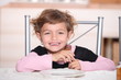 little girl smiling at table for afternoon snack