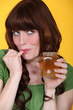 Playful woman eating honey