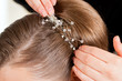 Stylist pinning up a bride's hairstyle Stylist pinning up a bride's hairstyle