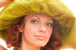 redhead in a green straw hat
