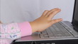 Little kid typimg on laptop keyboard