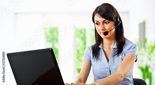 Photo: Call center operator using laptop Call center operator using laptop