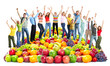 Group of happy people with fruits.