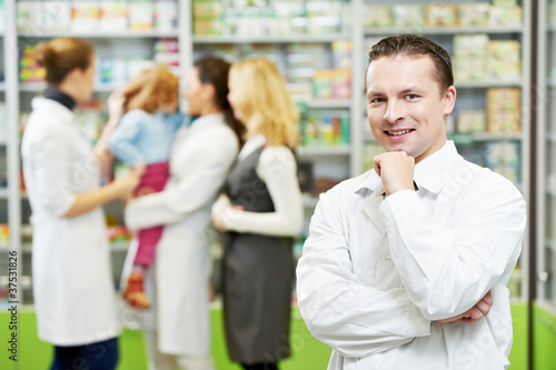 Photo: Confident pharmacy chemist man in drugstore Confident pharmacy chemist man in drugstore
