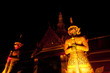 Night scene of statue giant story Ramayana at Wat Phra Kaew .