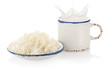Splashing milk in vintage cup and cottage cheese on white