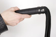 Photo: Black Leather Flogging Whip in female hand. Black Leather Flogging Whip in female hand.