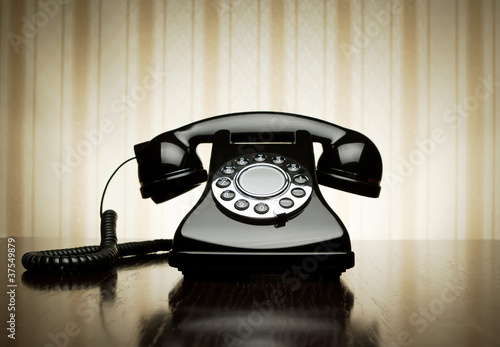 Photo: Vintage telephone over striped wallpaper Vintage telephone over striped wallpaper