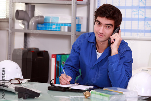 Photo: factory worker talking on the phone factory worker talking on the phone
