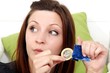 young woman with a condom (focus on face)
