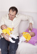 Multitasking -  father with his identical twin daughters