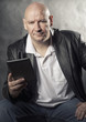 Man using e-reader tablet computer