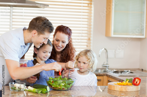 Photo: Family preparing salad together Family preparing salad together