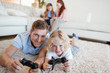 Father and son in the living room playing video games