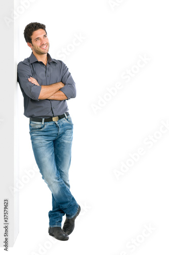 Photo: Thinking young man full length Thinking young man full length