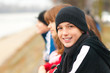Cute smiling teenage boy outside with friends