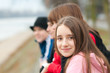 Pretty smiling girl outdoor with friends