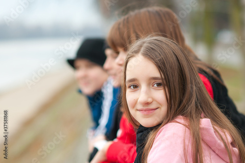Photo: Pretty smiling girl outdoor with friends Pretty smiling girl outdoor with friends