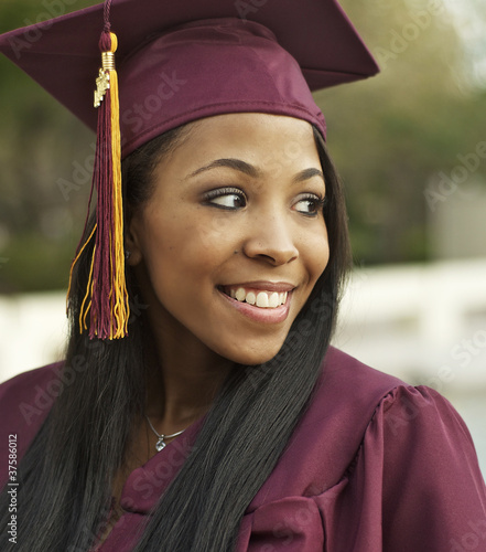 Photo: Woman wearing graduation cap and gown Woman wearing graduation cap and gown
