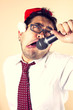 businessman wearing santa hat singing with microphone.