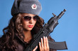 Beautiful young Russian woman holding an AK47 automatic rifle.