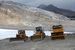 Three digger trucks on mountain