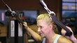 Woman doing pulldowns in gym