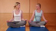 Two girls meditating in gym
