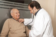 Doctor measuring blood pressure of senior patient at hospital