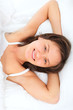 young smiling woman in bed