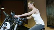 Woman on hometrainer holding thumbs up