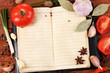 notebook for recipes and spices on wooden table