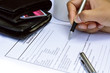 Business man fill out the donate information form.