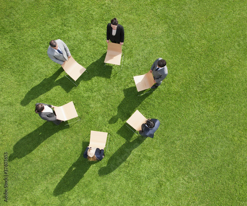 Photo: Business people in outdoor meeting standing in circle Business people in outdoor meeting standing in circle