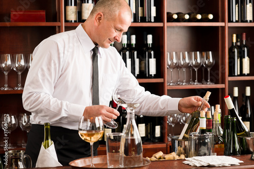 Photo: Wine bar waiter happy male in restaurant Wine bar waiter happy male in restaurant