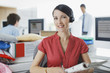 Businesswoman working at desk in headset
