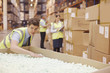 Worker packing box in warehouse