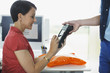 Woman writing signature on electronic device