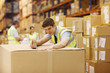 Worker taping box in warehouse