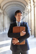 Businessman standing outdoors holding briefcase