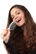 Photo: Woman singing into her hairbrush Woman singing into her hairbrush