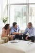Couple shaking hands with financial advisor