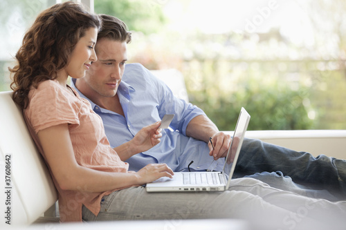 Photo: Couple shopping online with credit card Couple shopping online with credit card